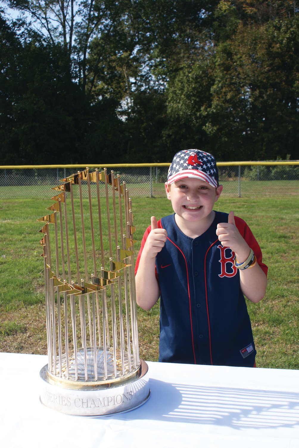 PROUD FAN: Red Sox fan Luca DePalo, 10, enjoyed having
his photo taken with the 2018 World Series trophy.